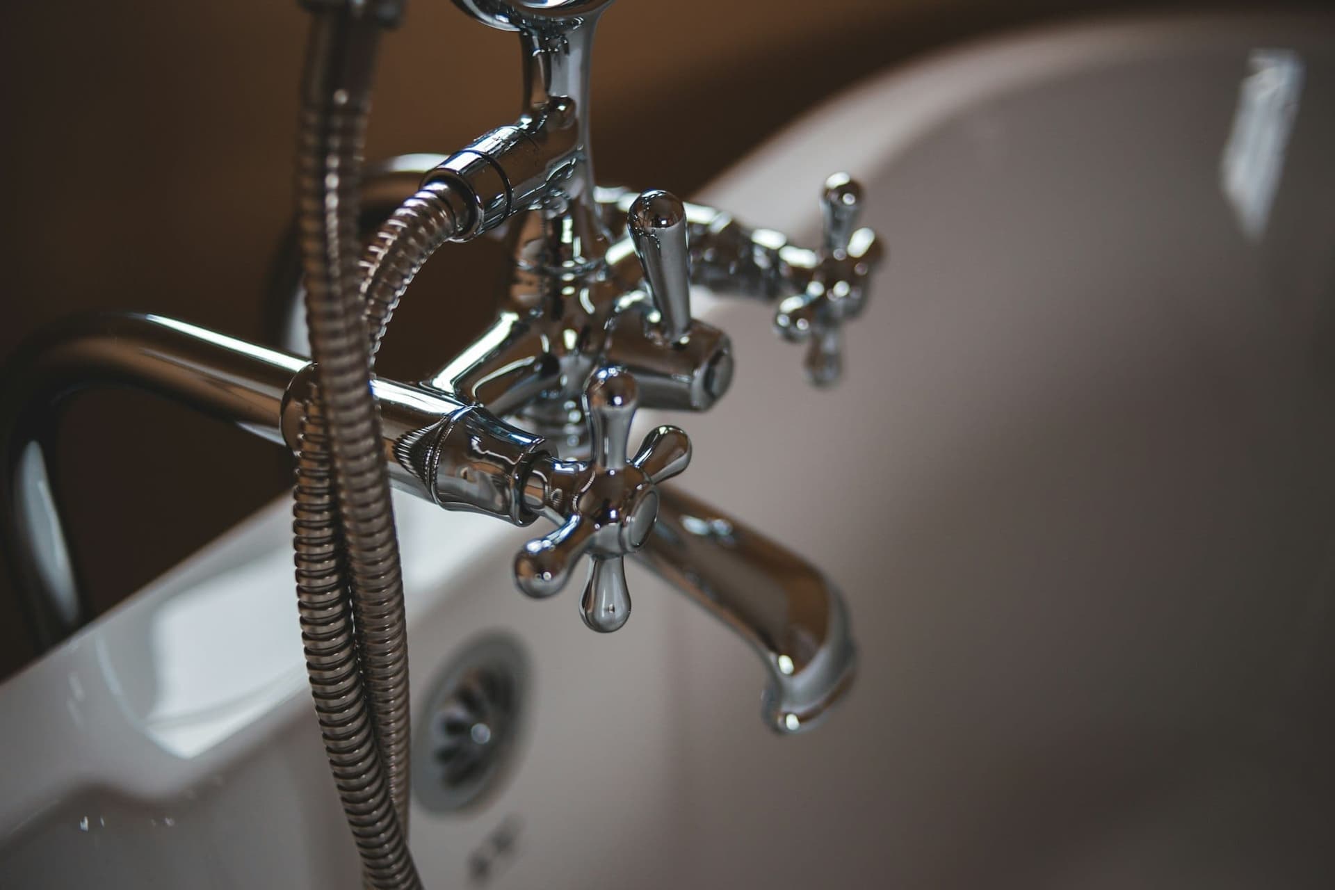 Silver tap on a white ceramic basin