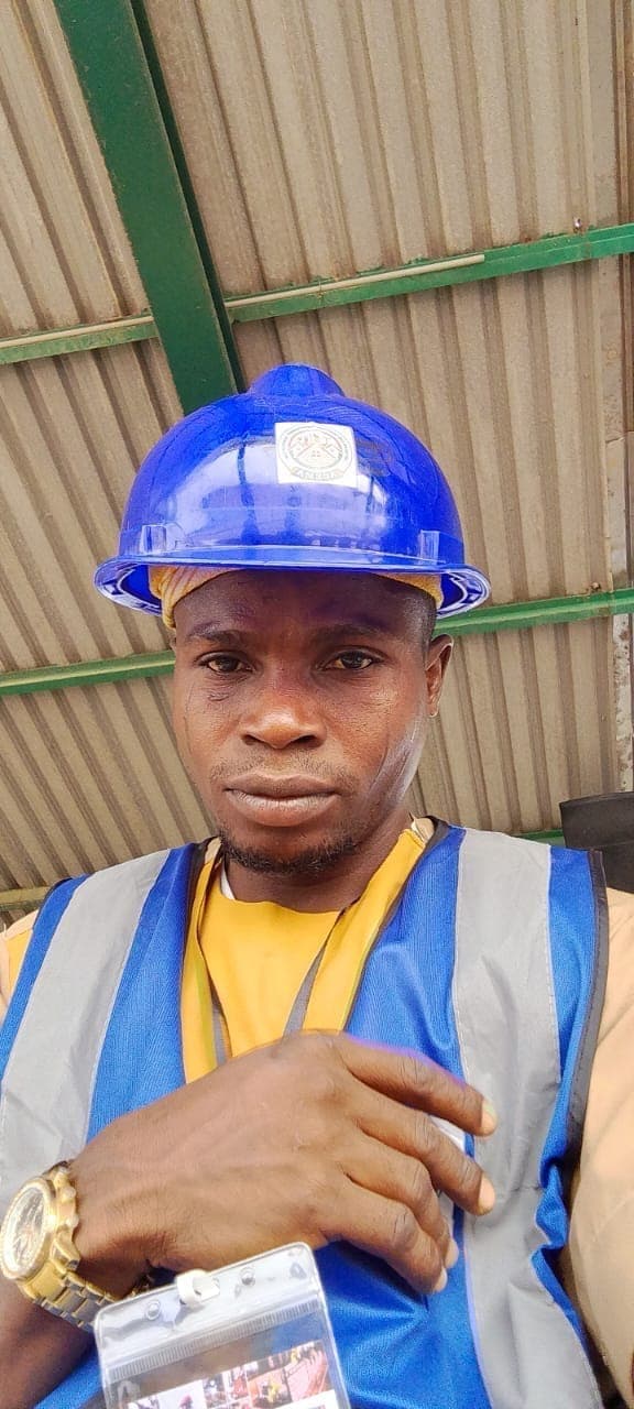 Princekay plumber in a blue hard hat and hi-vis vest on site