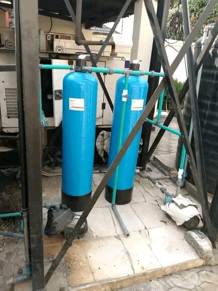Two blue water filtration vessels plumbed in with green PPR pipework